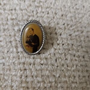 Vintage Lapel Pin Featuring Saint/Priest . Silver Tone.